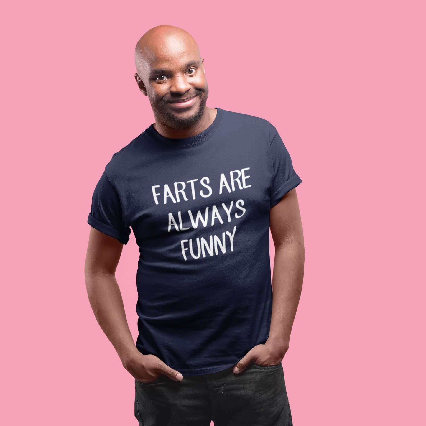 Smiling man wearing navy blue t-shirt with the phrase Farts are always funny printed on the front.
