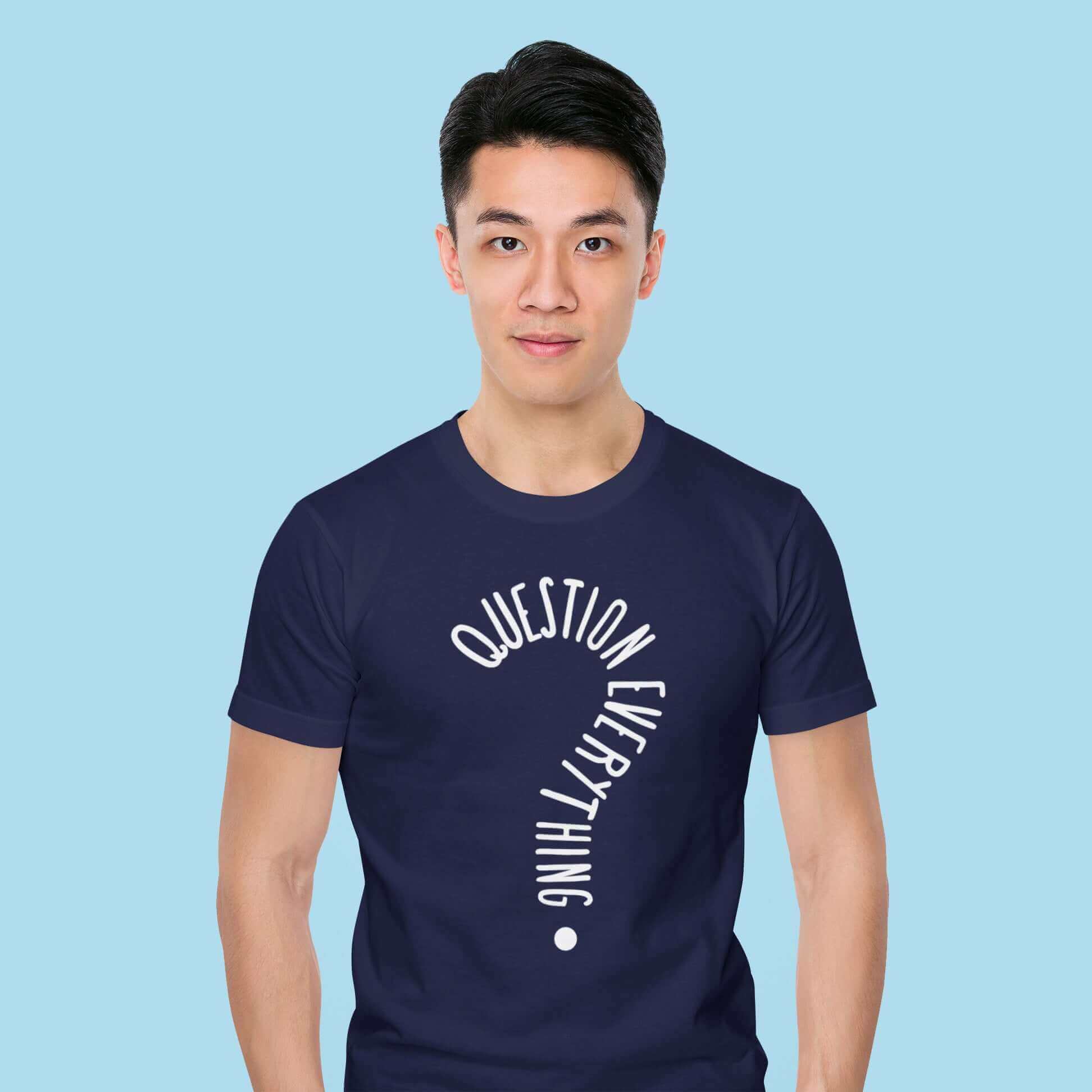 Man wearing a navy blue t-shirt with the words Question everything printed on the front. The words are in the shape of a question mark.