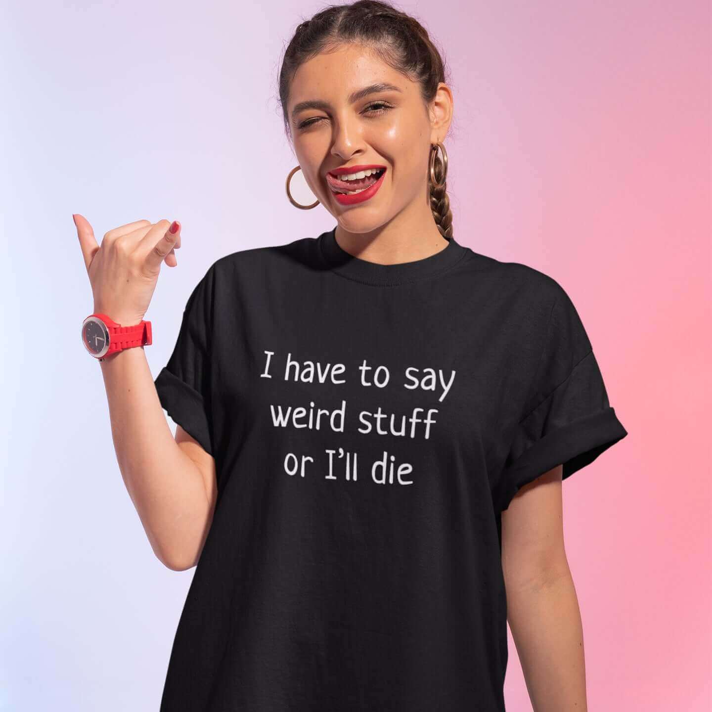 Woman making a funny face wearing a black t-shirt with the phrase I have to say weird stuff or I'll die printed on the front.
