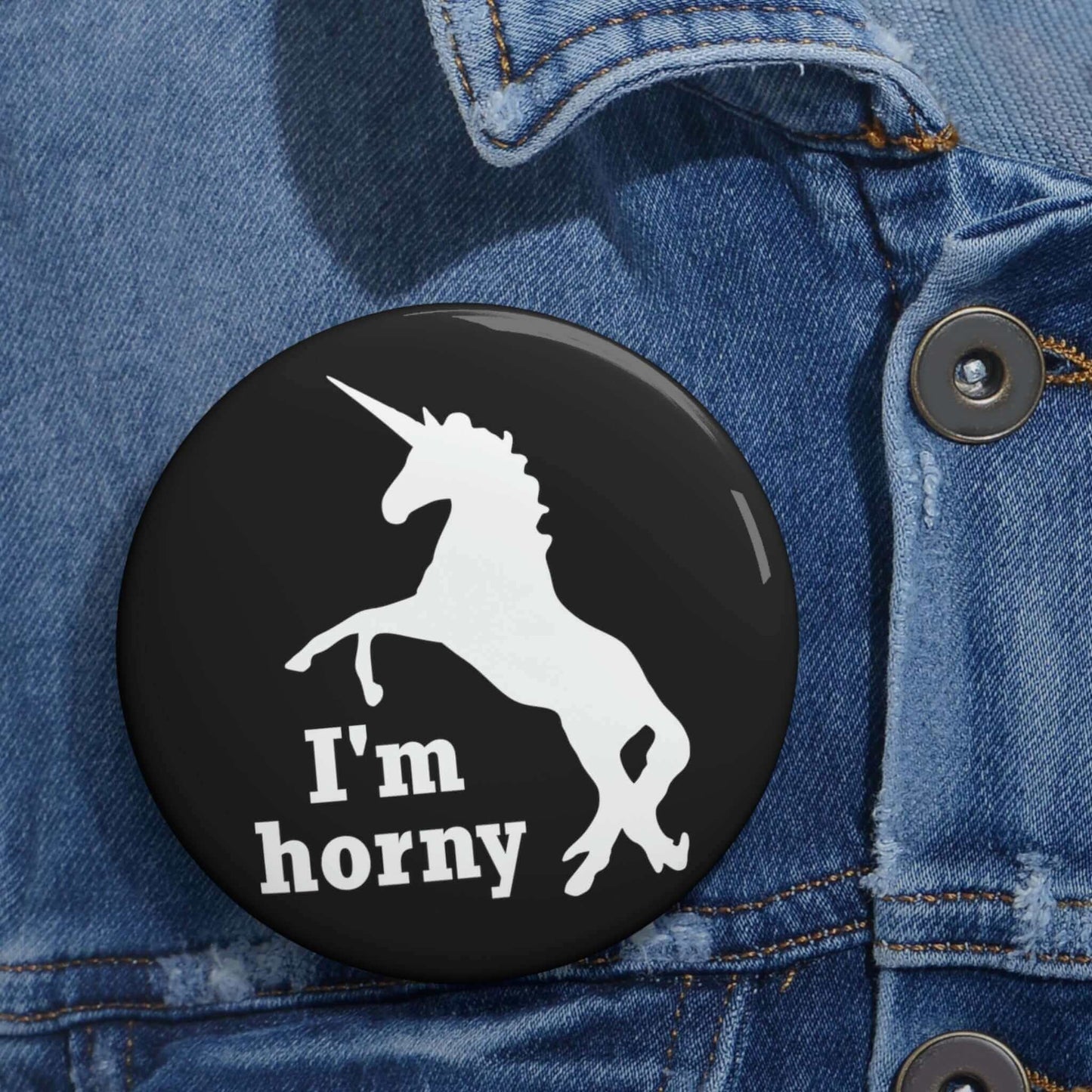 Funny pun pin-back button with silhouette image of a unicorn with the words I'm horny.