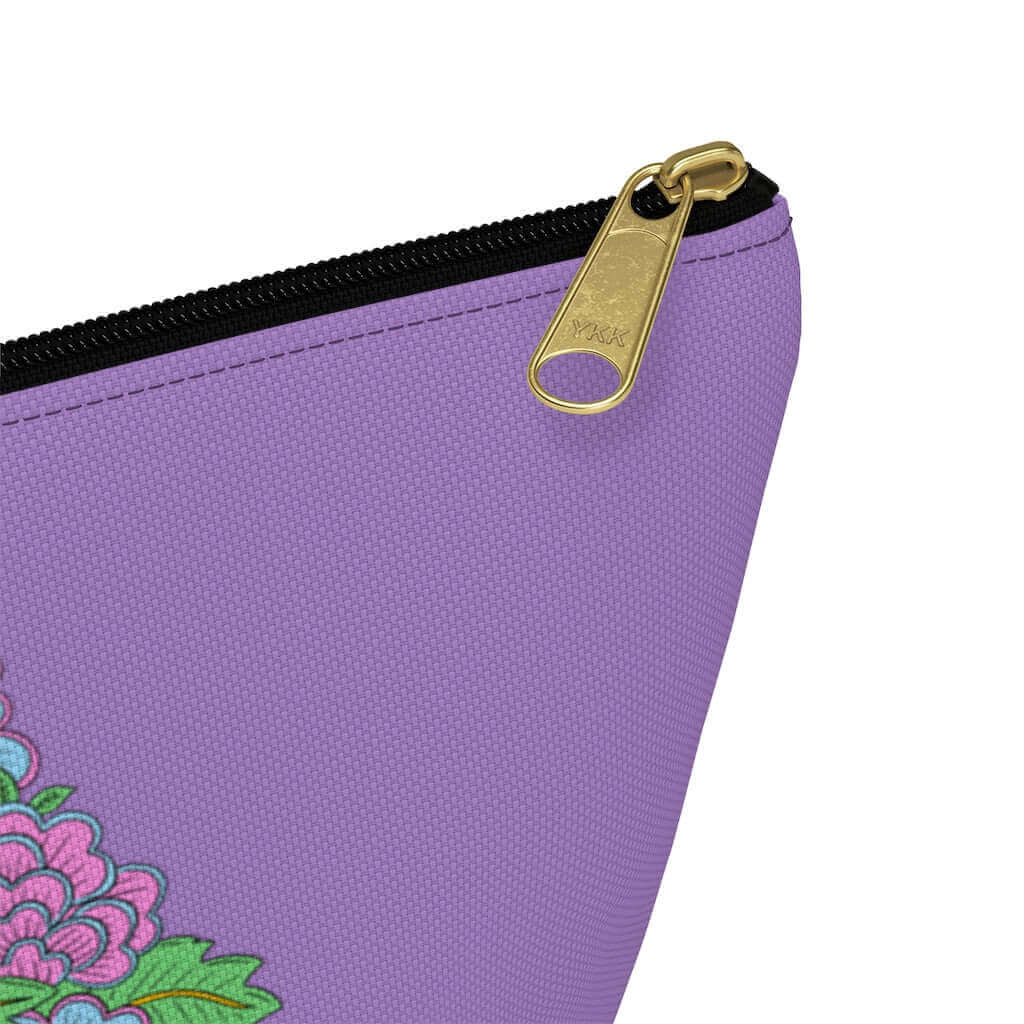 Light purple zipper pouch with graphic design that has the words Good vibes only layered over a pink wand vibrator with flowers around. The graphic design is printed on both sides of the bag.
