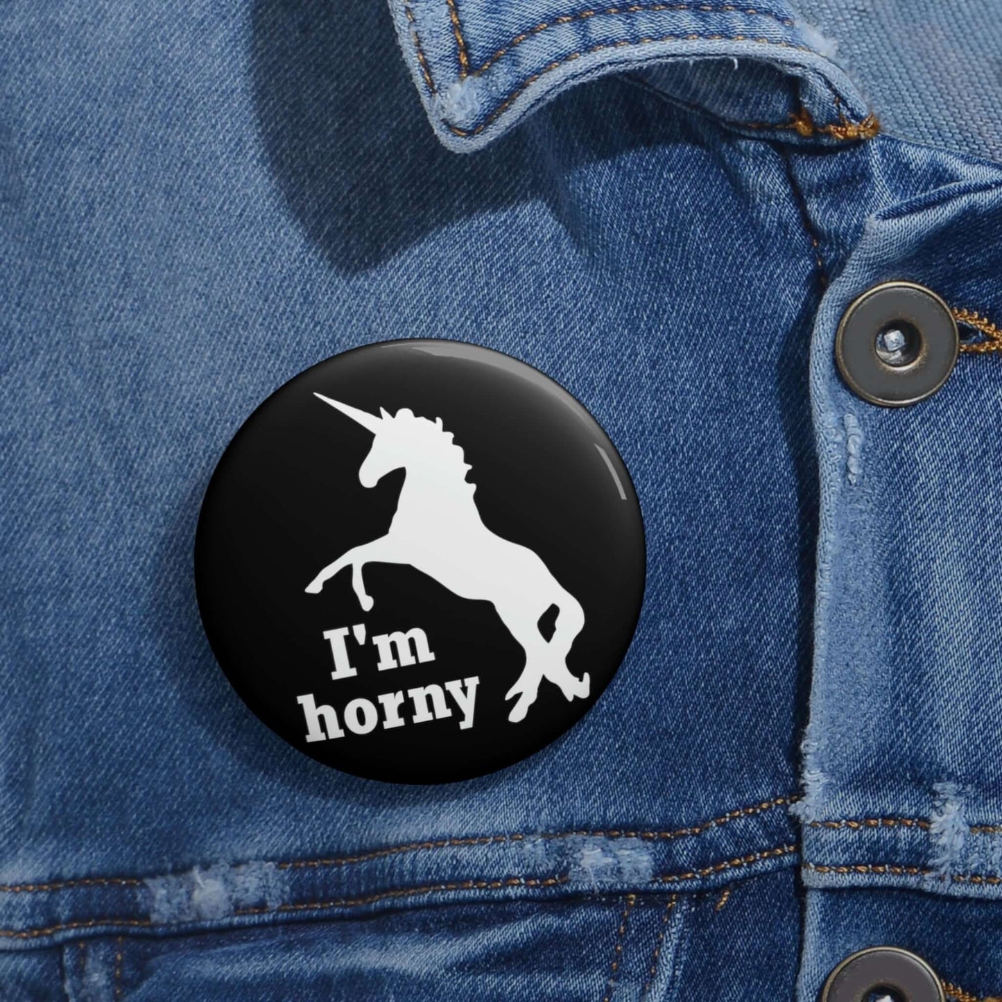 Funny pun pin-back button with silhouette image of a unicorn with the words I'm horny.