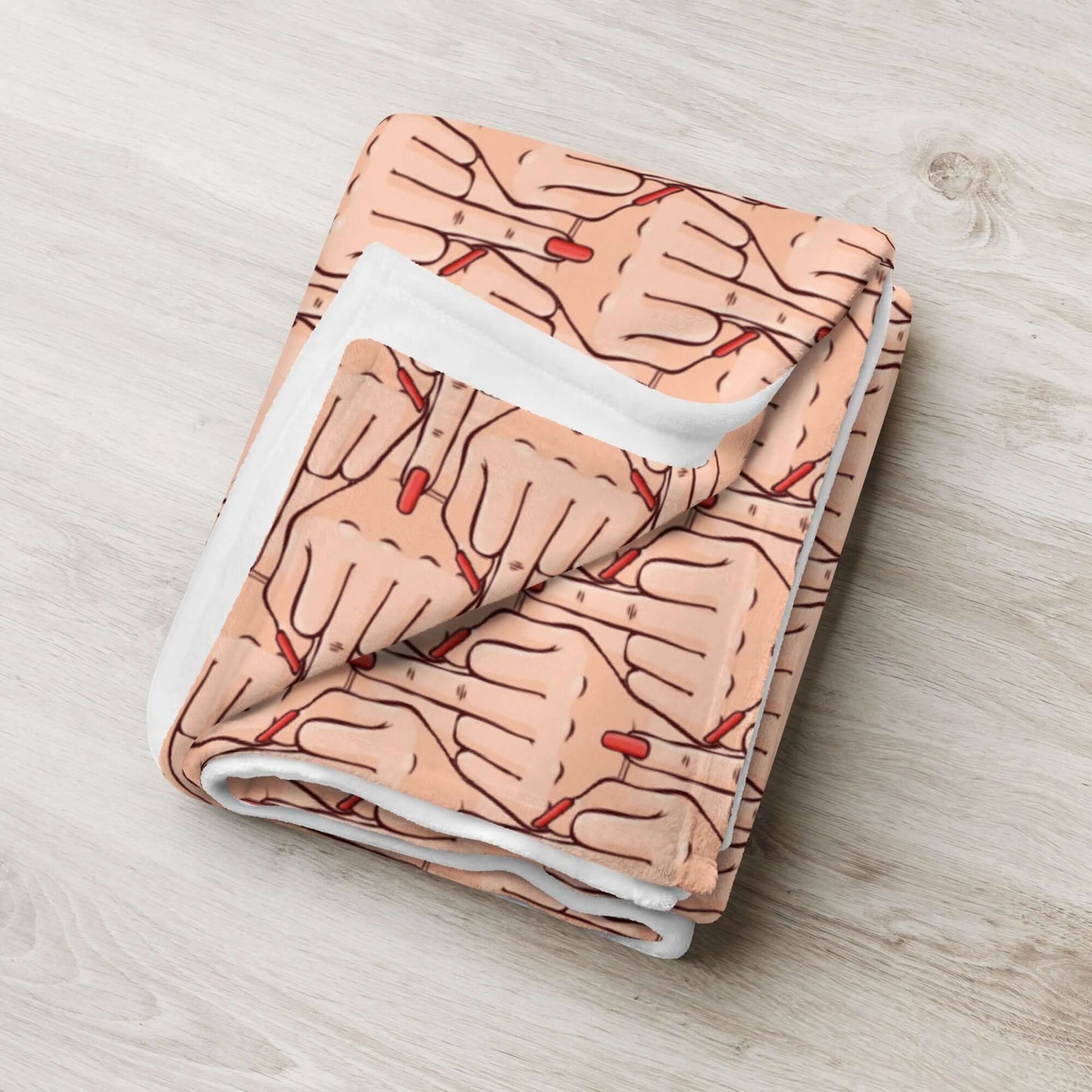 Folded throw blanket with graphic of Caucasian womans hand flipping the middle finger. The finger has a long red fingernail. The graphic is overlapping and printed all over.
