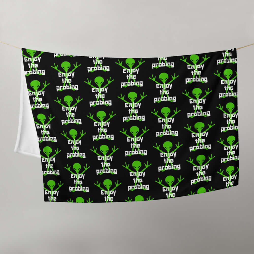Black fleece throw blanket with an image of an alien and the funny phrase Enjoy the probing printed all over the blanket.