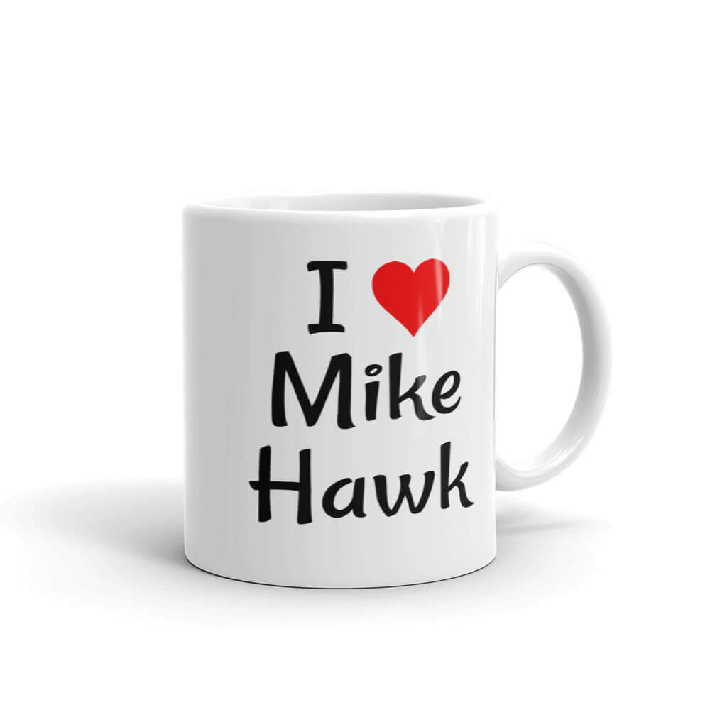 White ceramic coffee mug with the pun I heart Mike Hawk printed on both sides of the mug.