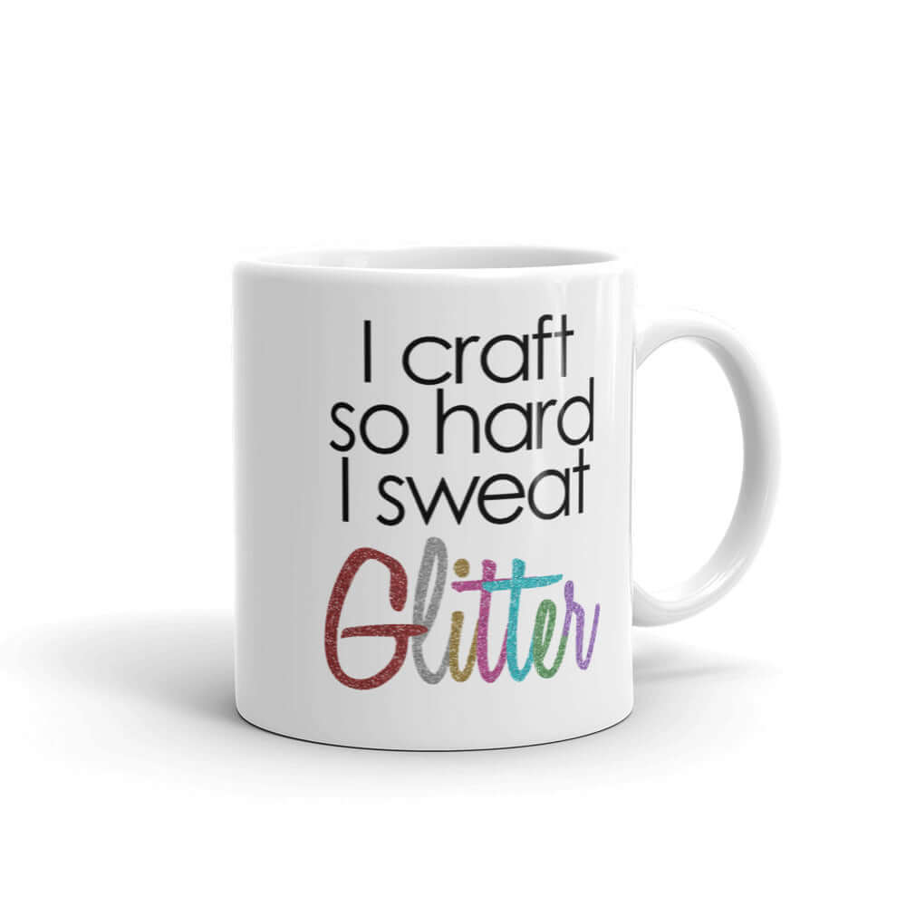 White ceramic coffee mug with the phrase I craft so hard I sweat glitter printed on both sides. The word Glitter is printed in multi colored font that looks like glitter.