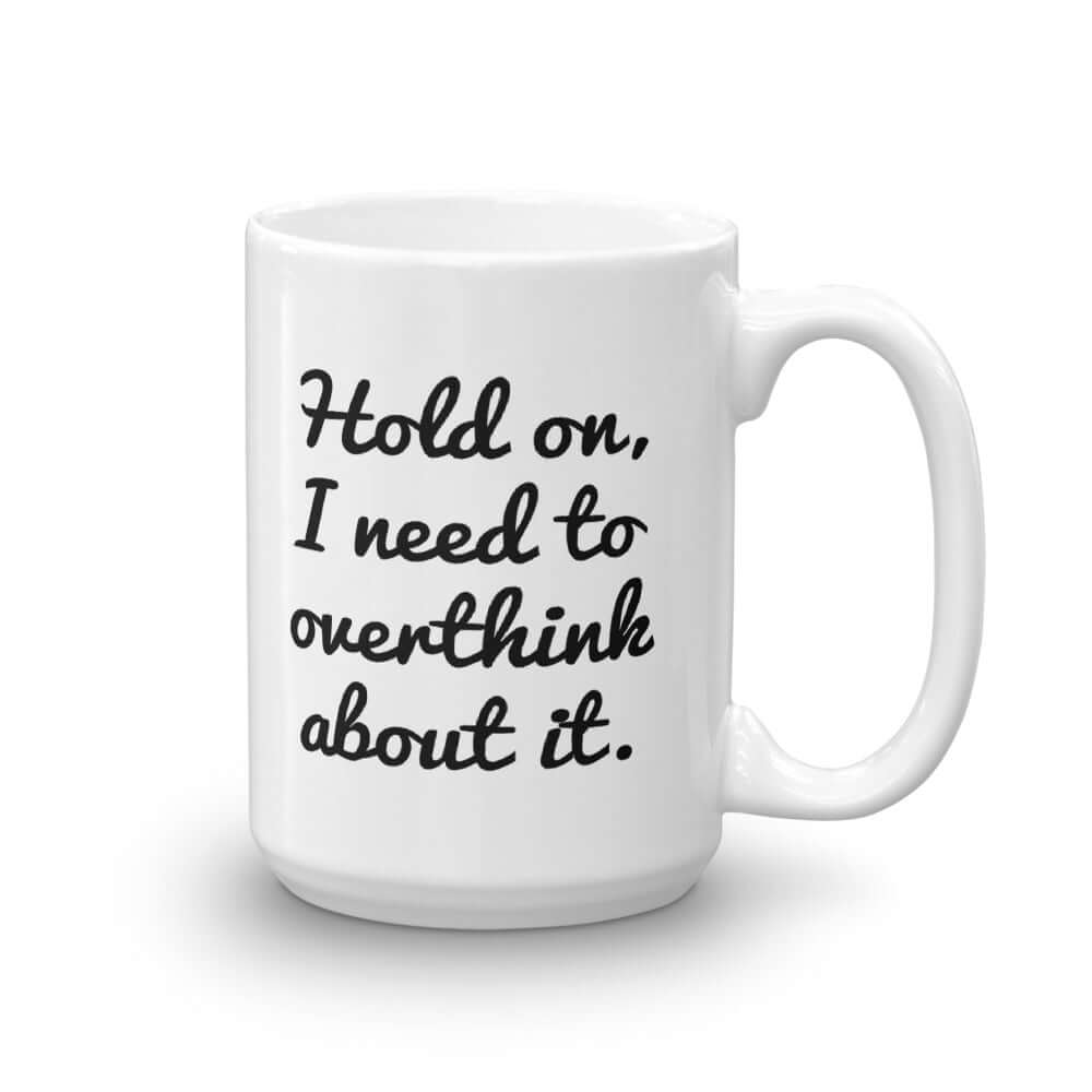 White ceramic coffee mug with the funny phrase Hold on, let me overthink about it printed on both sides of the mug.