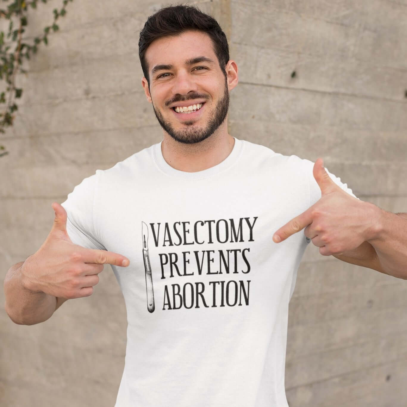 Man wearing white t-shirt that has an image of a surgical scalpel and the phrase Vasectomy prevents abortion printed on the front.