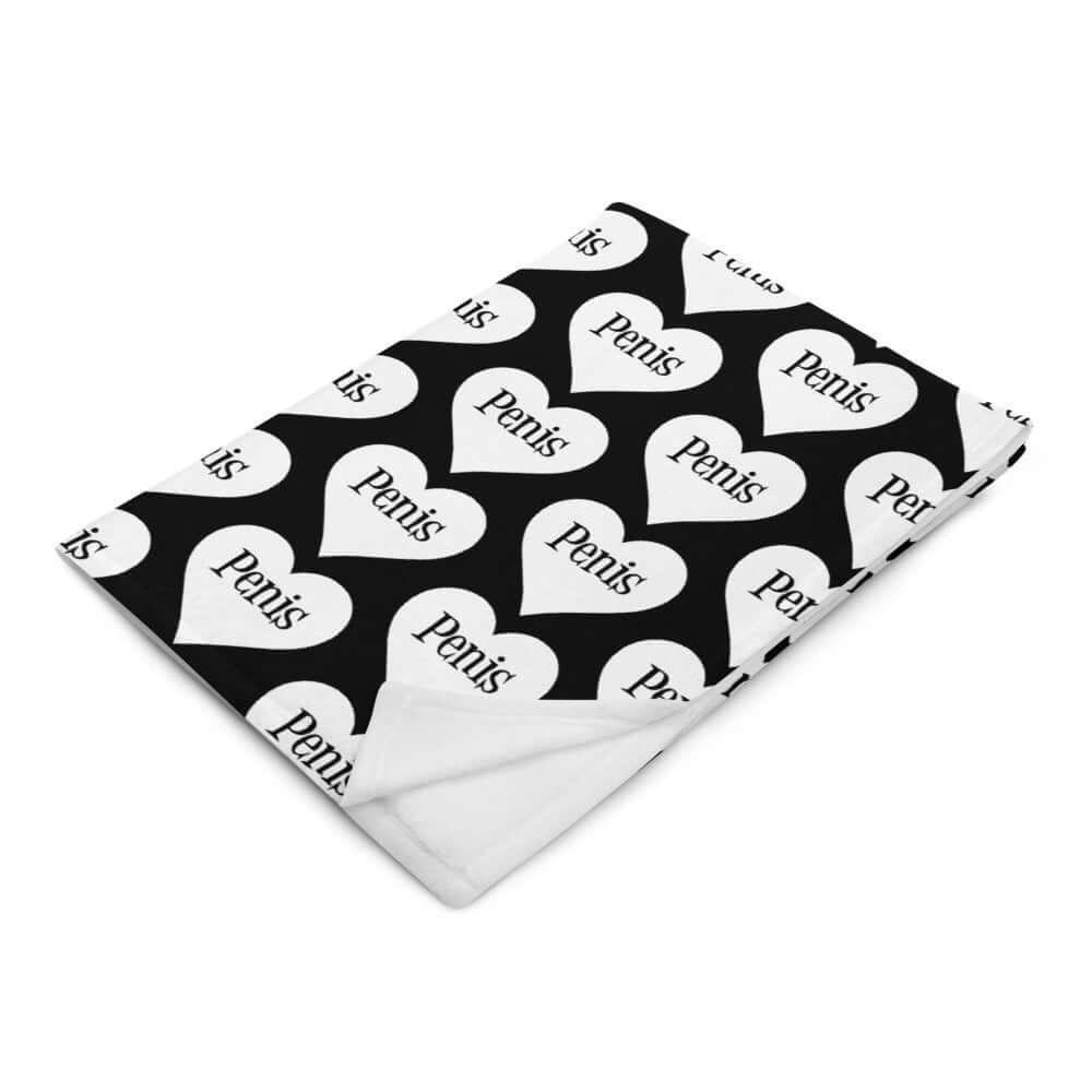 Black throw blanket with a heart image printed all over the blanket. The word penis is inside the heart