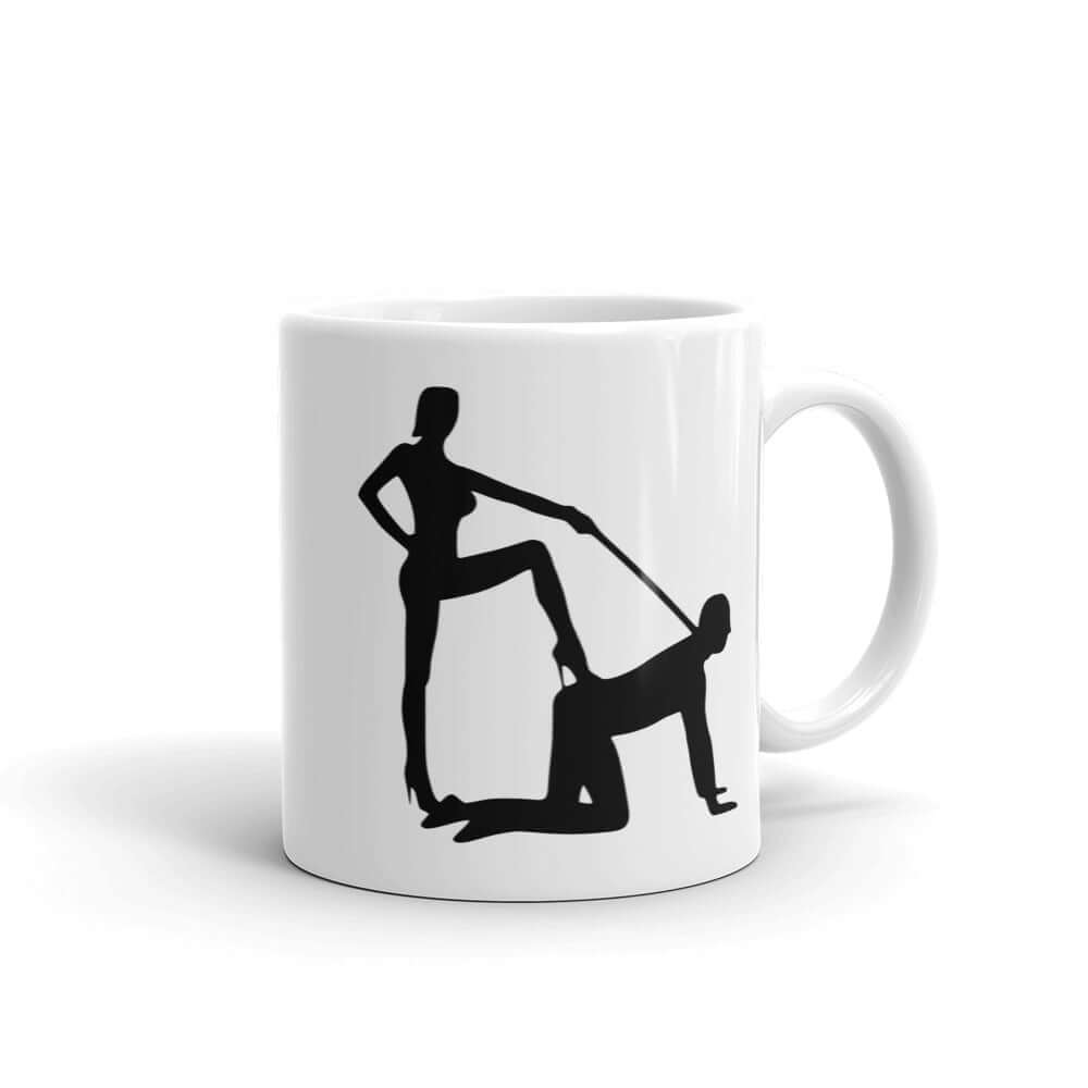 White ceramic coffee mug with the image of a silhouette of a man on his hands and knees and a dominatrix holding his leash printed on both sides.