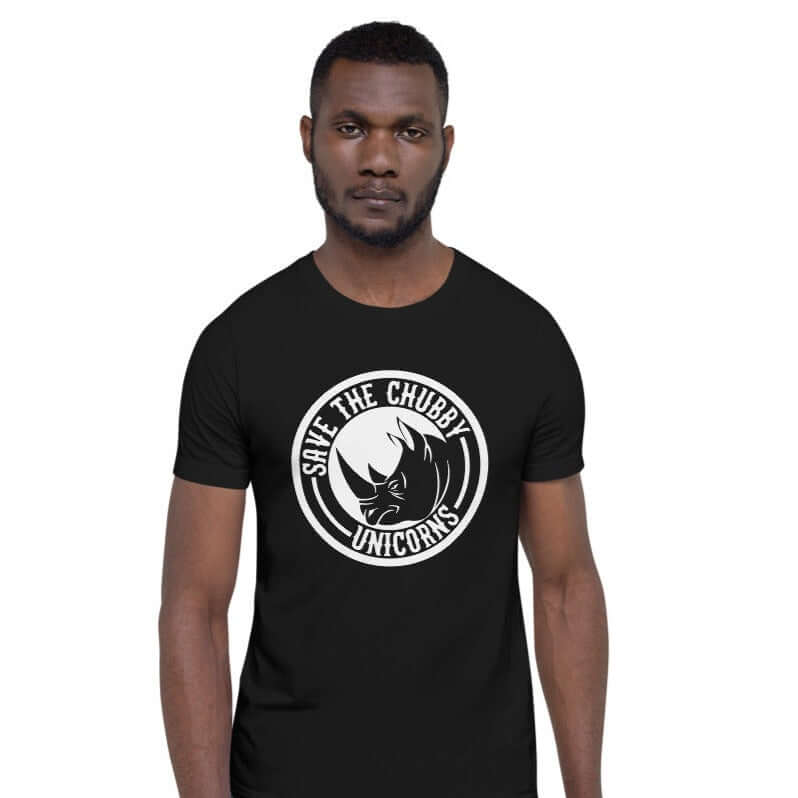 Man wearing a black t-shirt with a funny graphic of a rhinoceros & the words Save the chubby unicorns printed on the front.