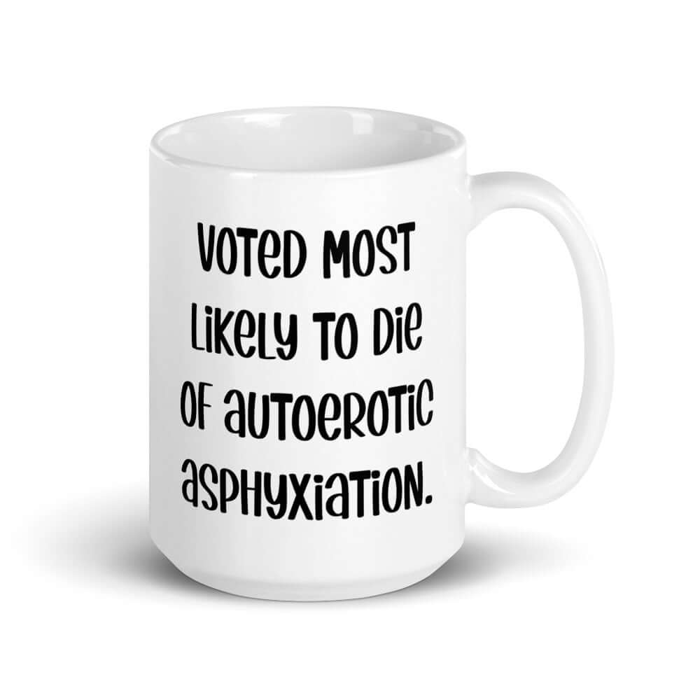 White ceramic coffee mug with the phrase Voted most likely to die of autoerotic asphyxiation printed on both sides.