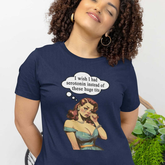 Woman wearing a navy blue t-shirt with an image of a busty pin-up lady with thought bubble that says I wish I had serotonin instead of these huge tits printed on the front.