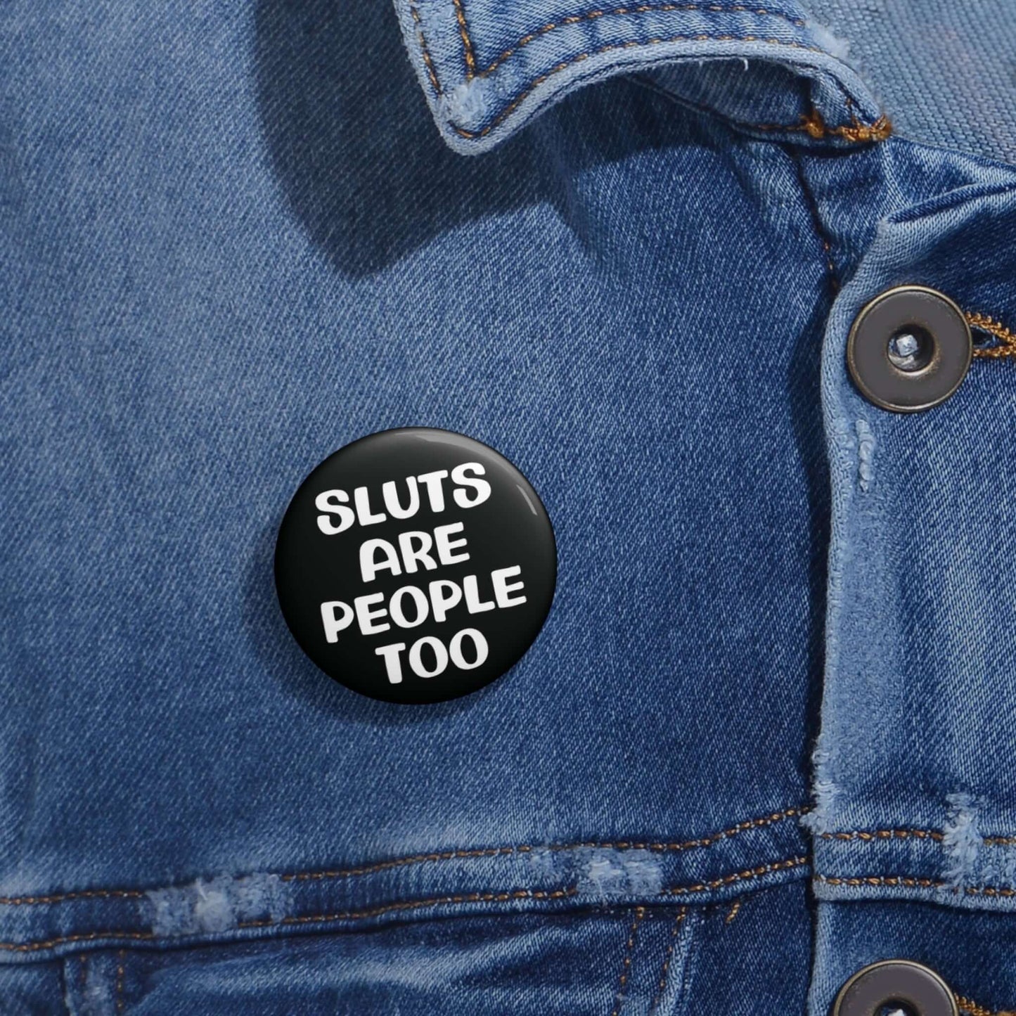 Black pinback button that says Sluts are people too.