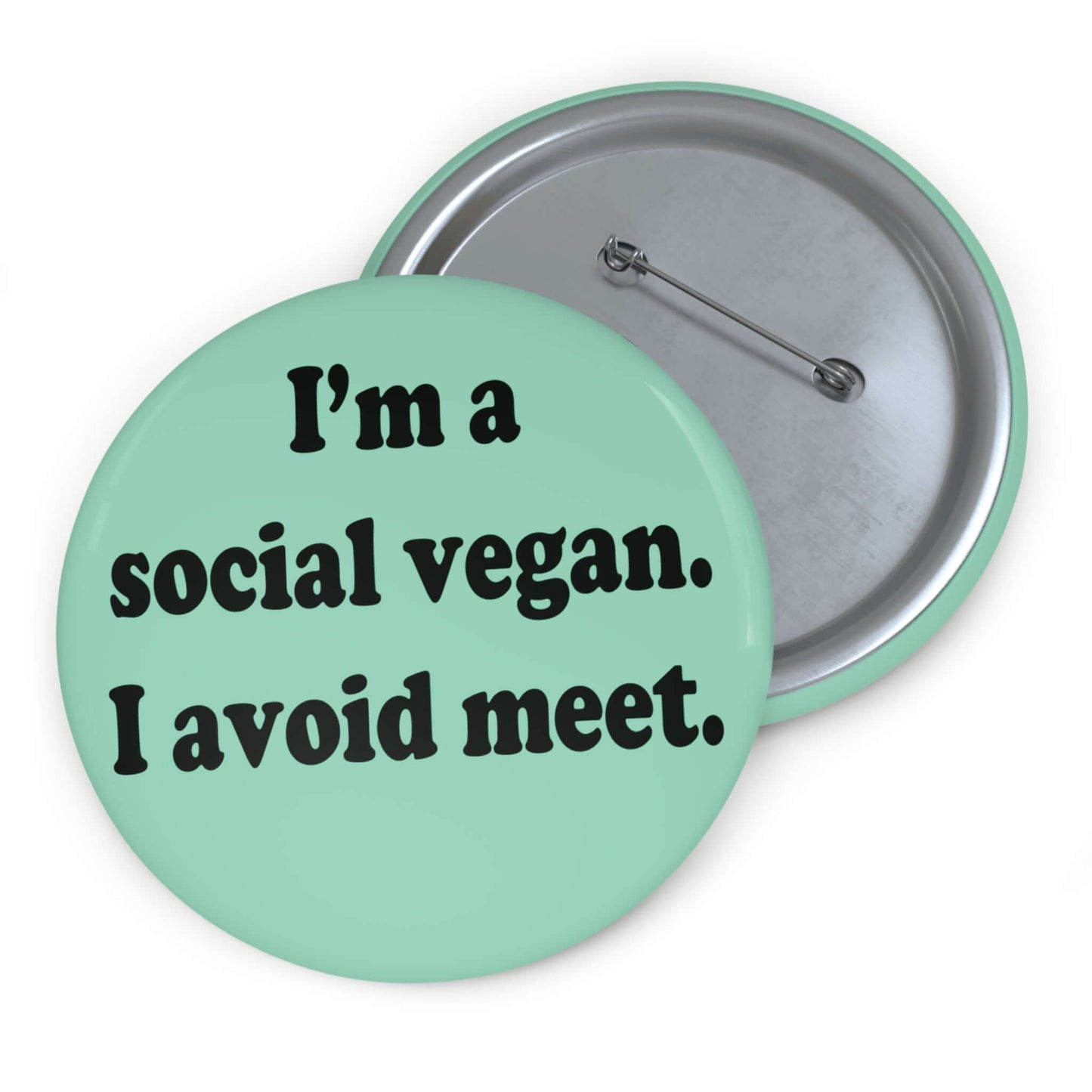 Mint green pinback button that says Im a social vegan, I avoid meet. Meet is spelled M E E T instead of M E A T.