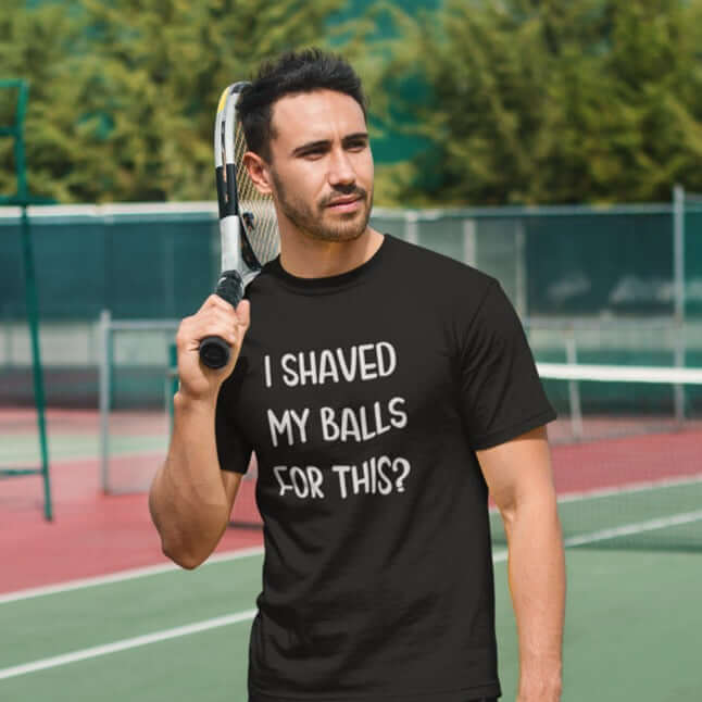 Man on a tennis court wearing a black t-shirt with the phrase I shaved my balls for this printed on the front.