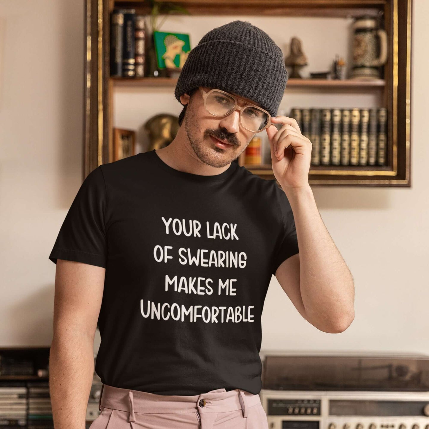 Man wearing a black t-shirt with the phrase Your lack of swearing makes me uncomfortable printed on the front.