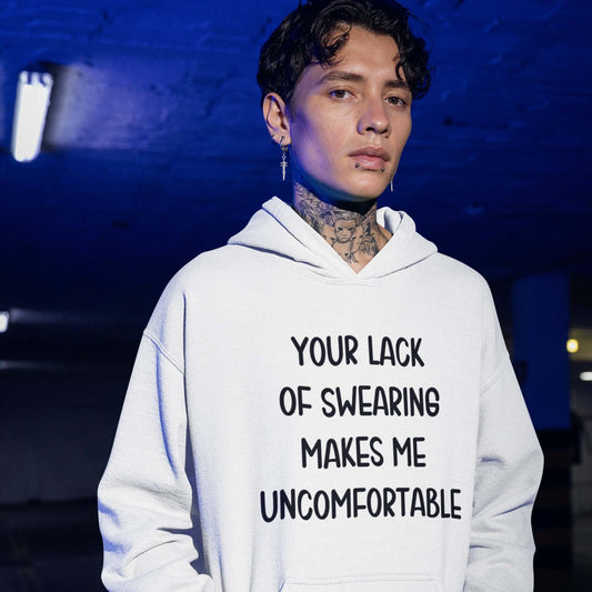 Man wearing a white hoodie sweatshirt with the phrase Your lack of swearing makes me uncomfortable printed on the front.