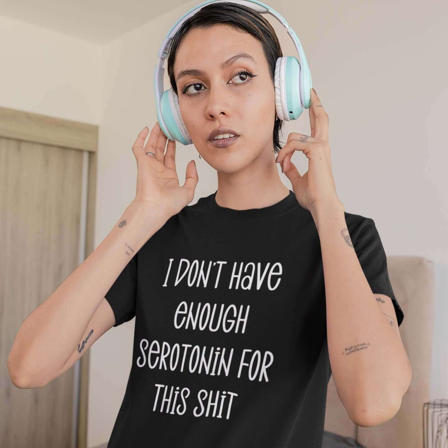 Woman wearing a black t-shirt with the phrase I don't have enough serotonin for this shit printed on the front.