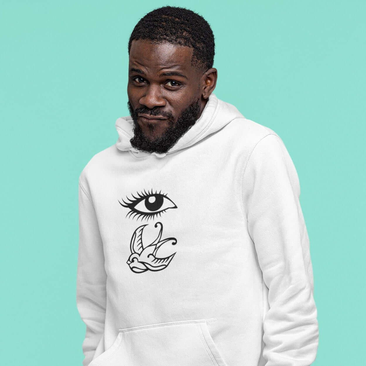 Man wearing white hoodie sweatshirt with outline drawing of an eye and a swallow bird printed on the front.