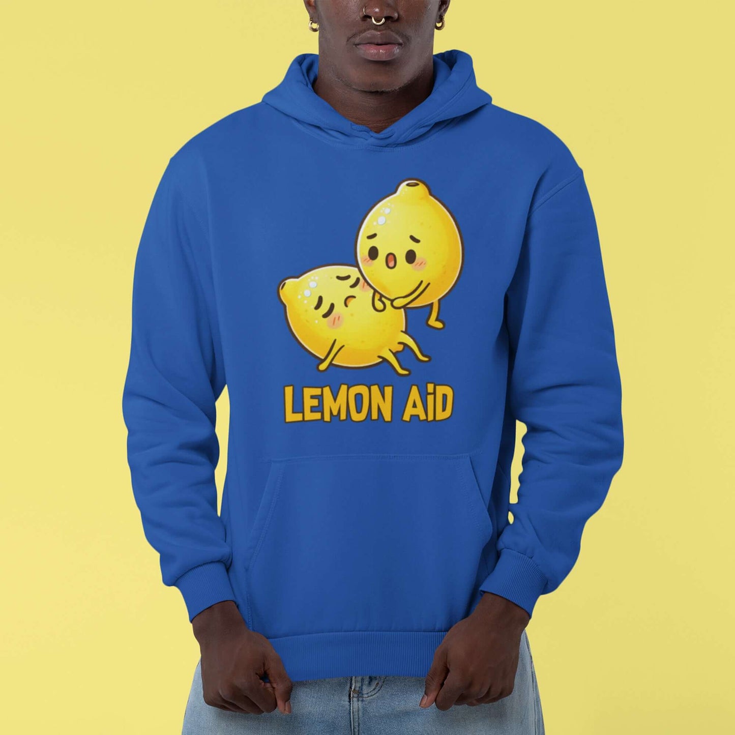 Man wearing a royal blue hoodie sweatshirt with image of 2 cartoon lemons. One lemon is giving the other lemon CPR. The words Lemon Aid is under the lemons. The graphic is printed on the front.