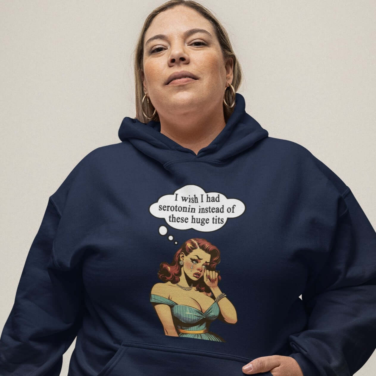 Plus size woman wearing a navy blue hoodie sweatshirt with an image of a busty pin-up lady with thought bubble that says I wish I had serotonin instead of these huge tits.