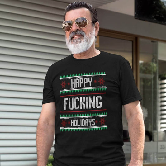 Man wearing a black t-shirt with the phrase Happy fucking holidays printed on the front. The graphics are printed like a knitted Christmas sweater.