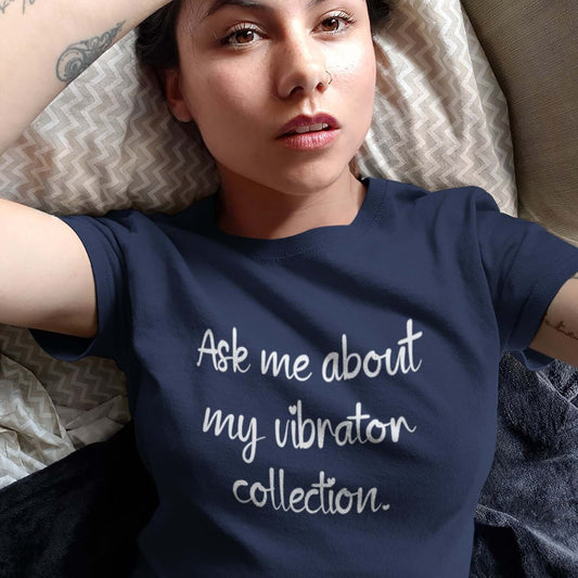 Woman wearing a navy blue t-shirt with the phrase Ask me about my vibrator collection printed on the front.