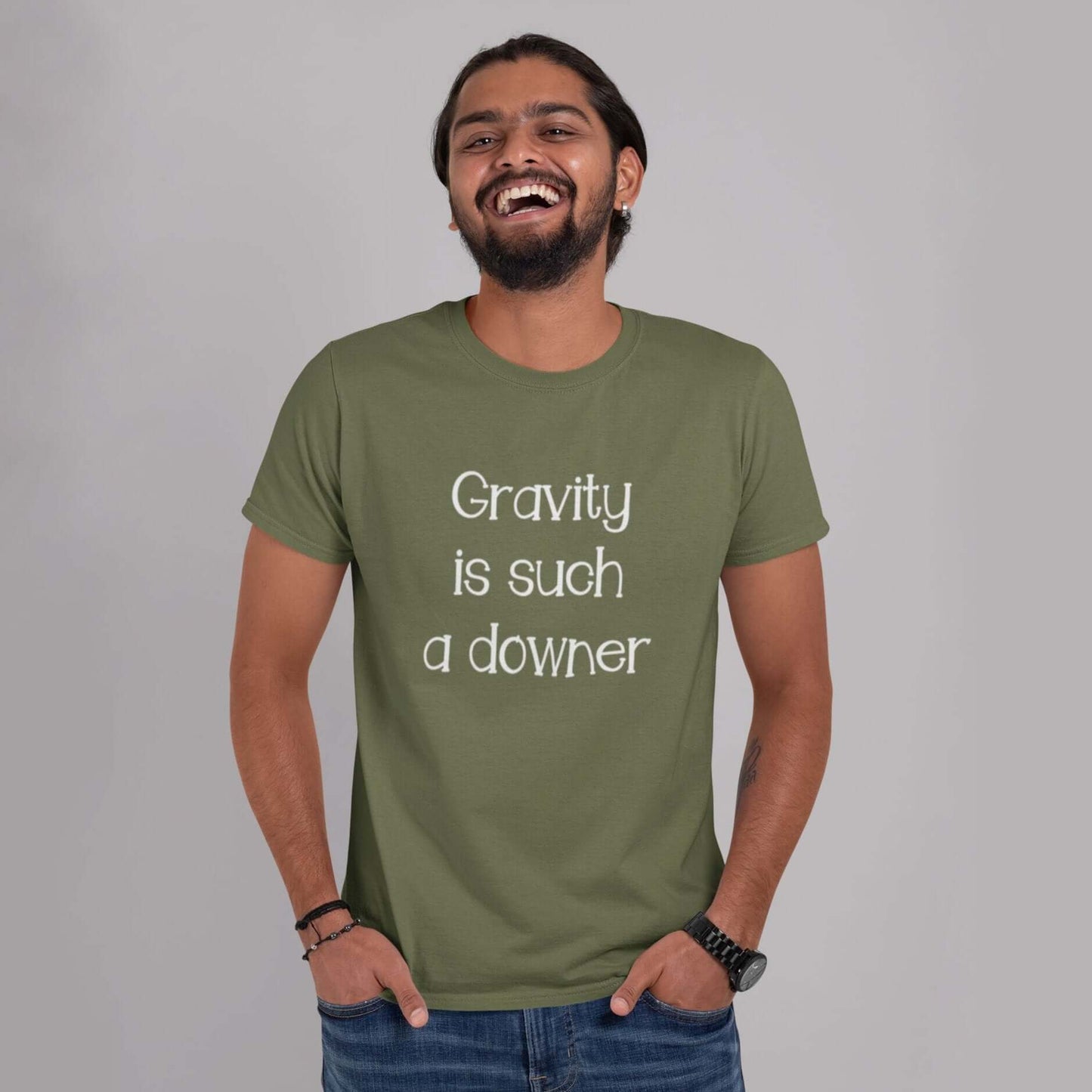 Smiling man wearing a military green t-shirt with the words Gravity is such a downer printed on the front.