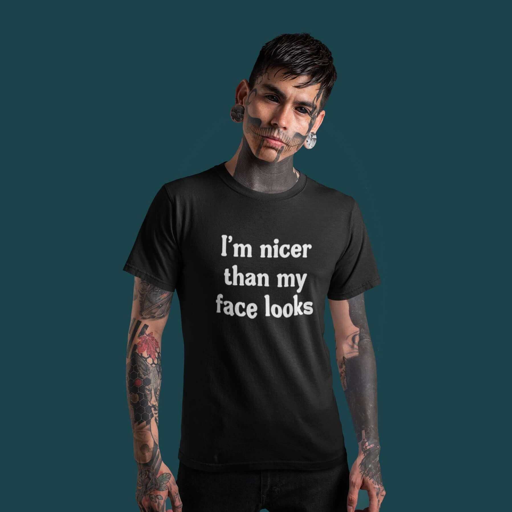 Alternative man with heavily tattooed face wearing black t-shirt that says I'm nicer than my face looks printed on the front.