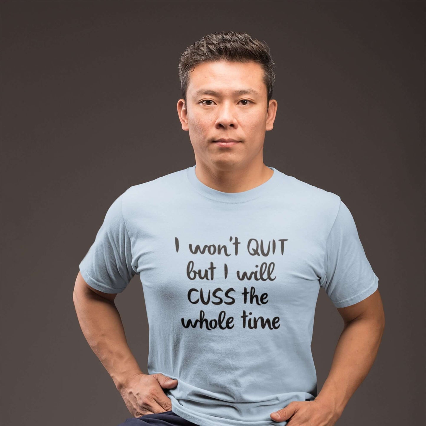 Man wearing a light blue t-shirt with the phrase I won't quit but I will cuss the whole time printed on the front.