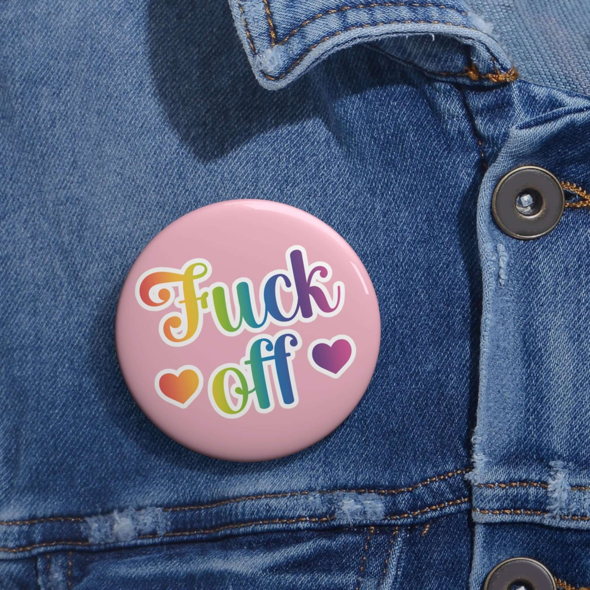 Fuck off rainbow font 80's style pinback button with pink background.