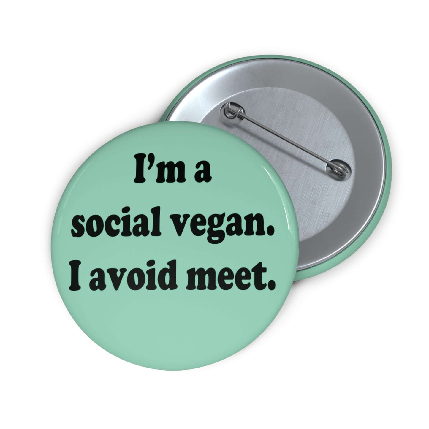 Mint green pinback button that says Im a social vegan, I avoid meet. Meet is spelled M E E T instead of M E A T.