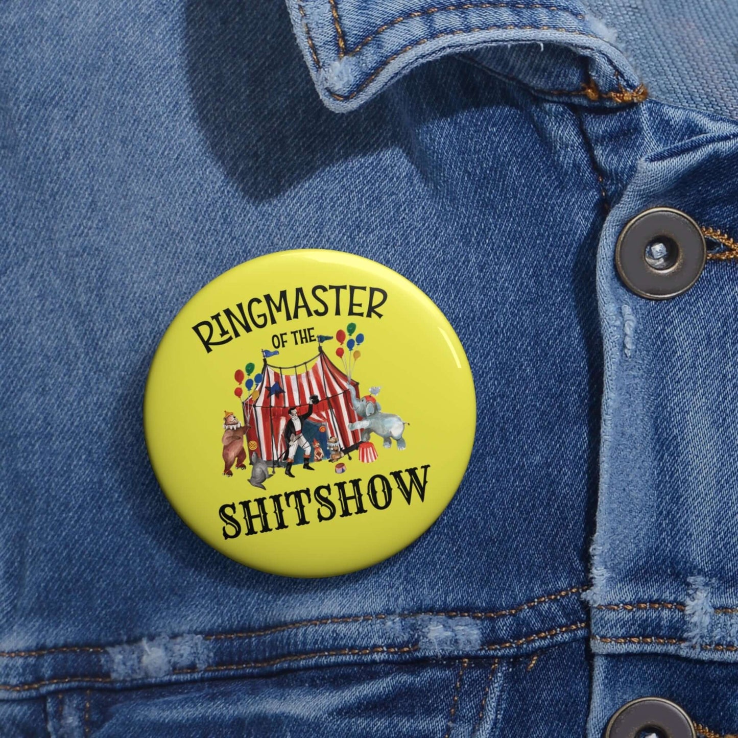 Yellow pinback button with circus graphics and the phrase Ringmaster of the Shitshow.