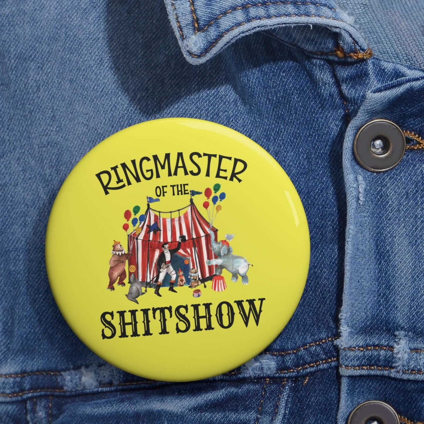 Yellow pinback button with circus graphics and the phrase Ringmaster of the Shitshow.