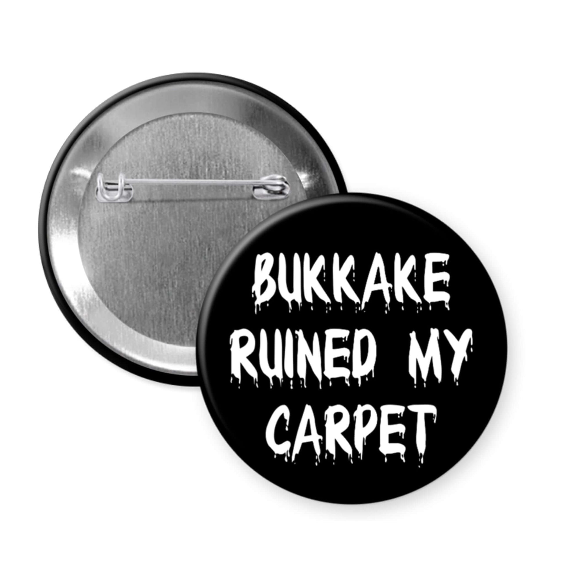 Black pinback button that says Bukkake ruined my carpet.