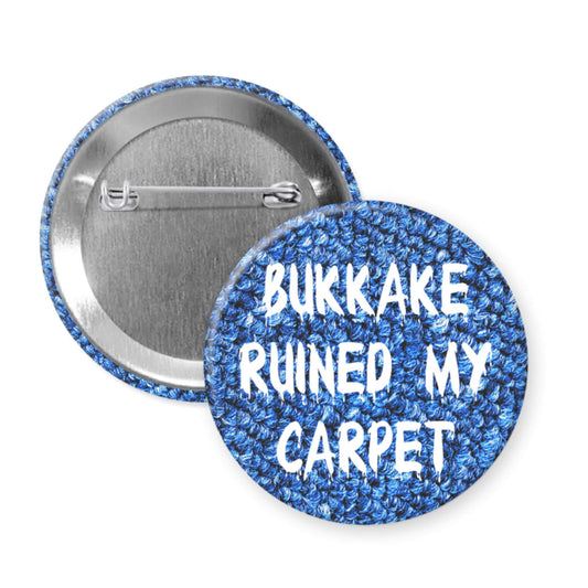 Blue pinback button that says Bukkake ruined my carpet.