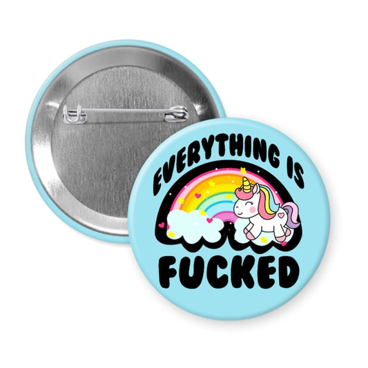 Button badge with unicorn and rainbow design on a light blue background