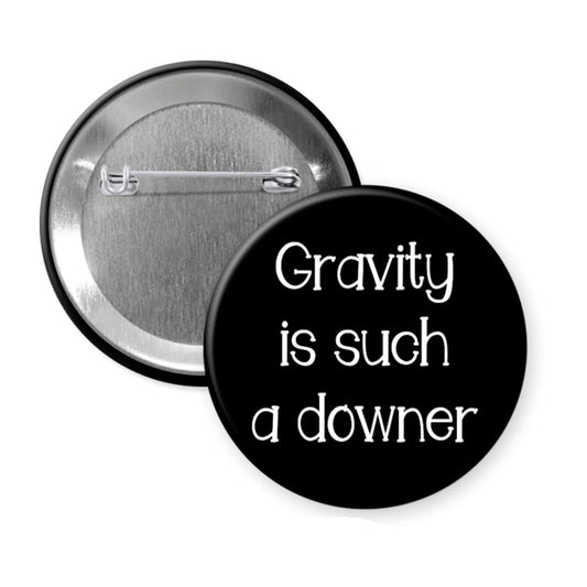 Button badge with 'Gravity is such a downer' text on a black background