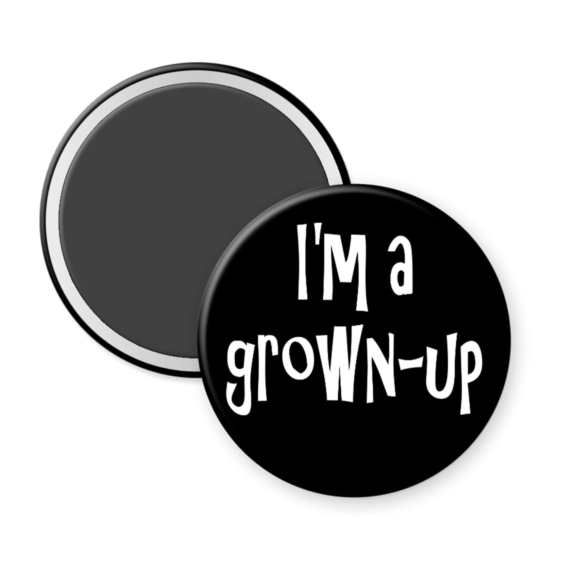 Round black magnet with 'I'm a grown-up' text on a white background