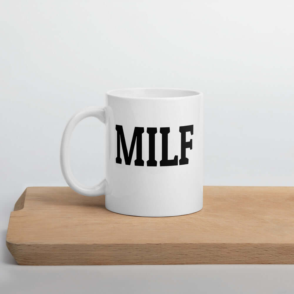 White ceramic coffee mug with the acronym MILF printed on both sides.