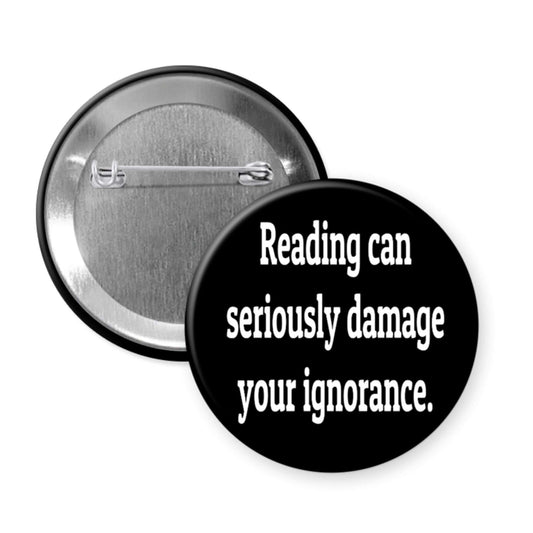 Pinback button that says Reading can seriously damage your ignorance.
