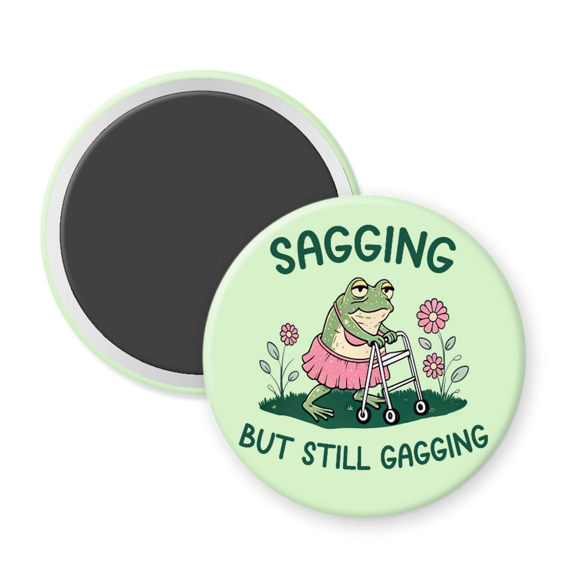 Round green magnet with a frog illustration and text 'Sagging but still gagging' on a white background