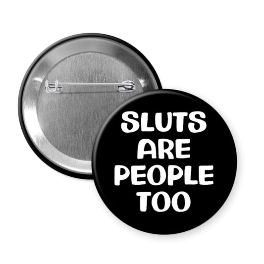 Button badge with 'Sluts are people too' text on a black background
