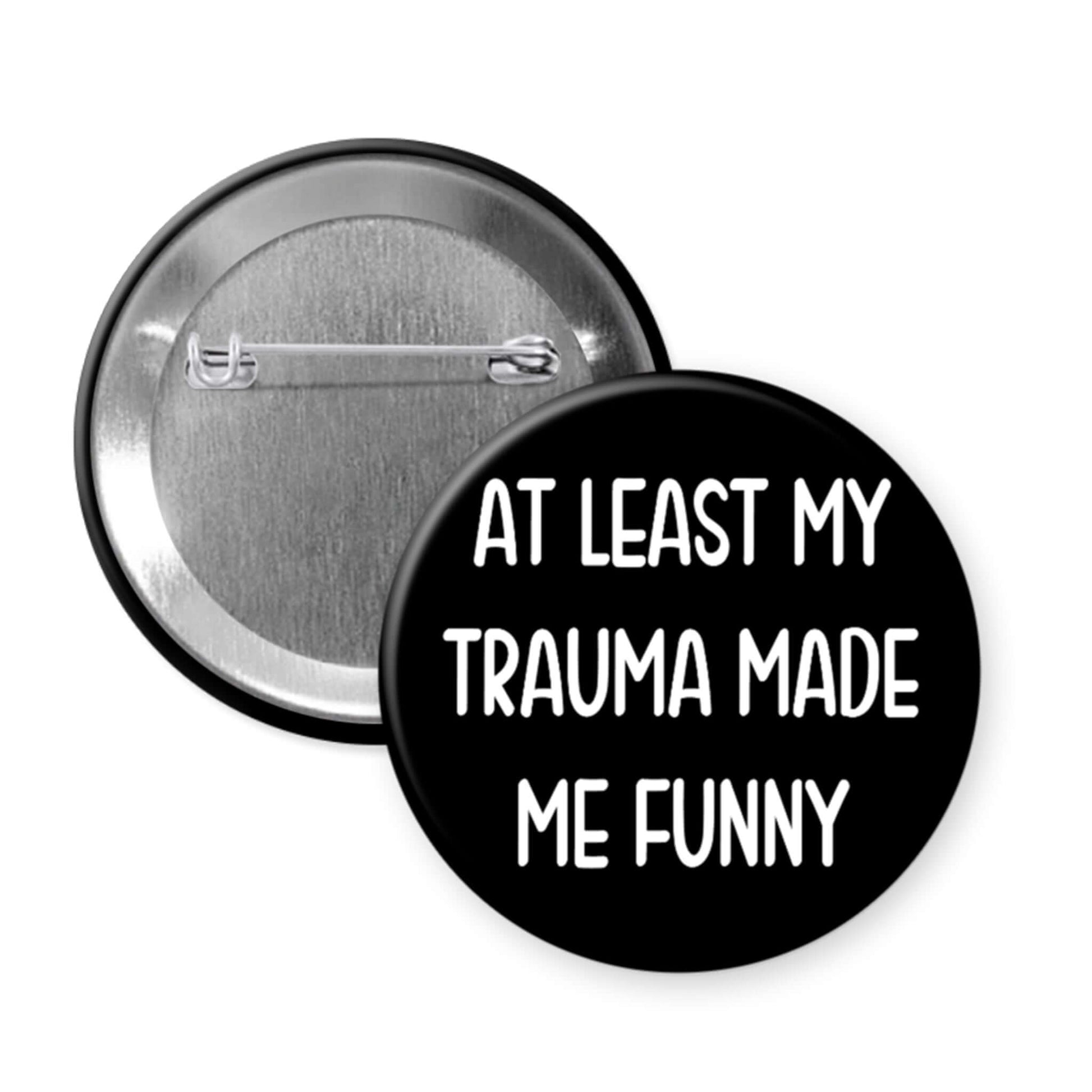 Button badge with 'At least my trauma made me funny' text on a white background