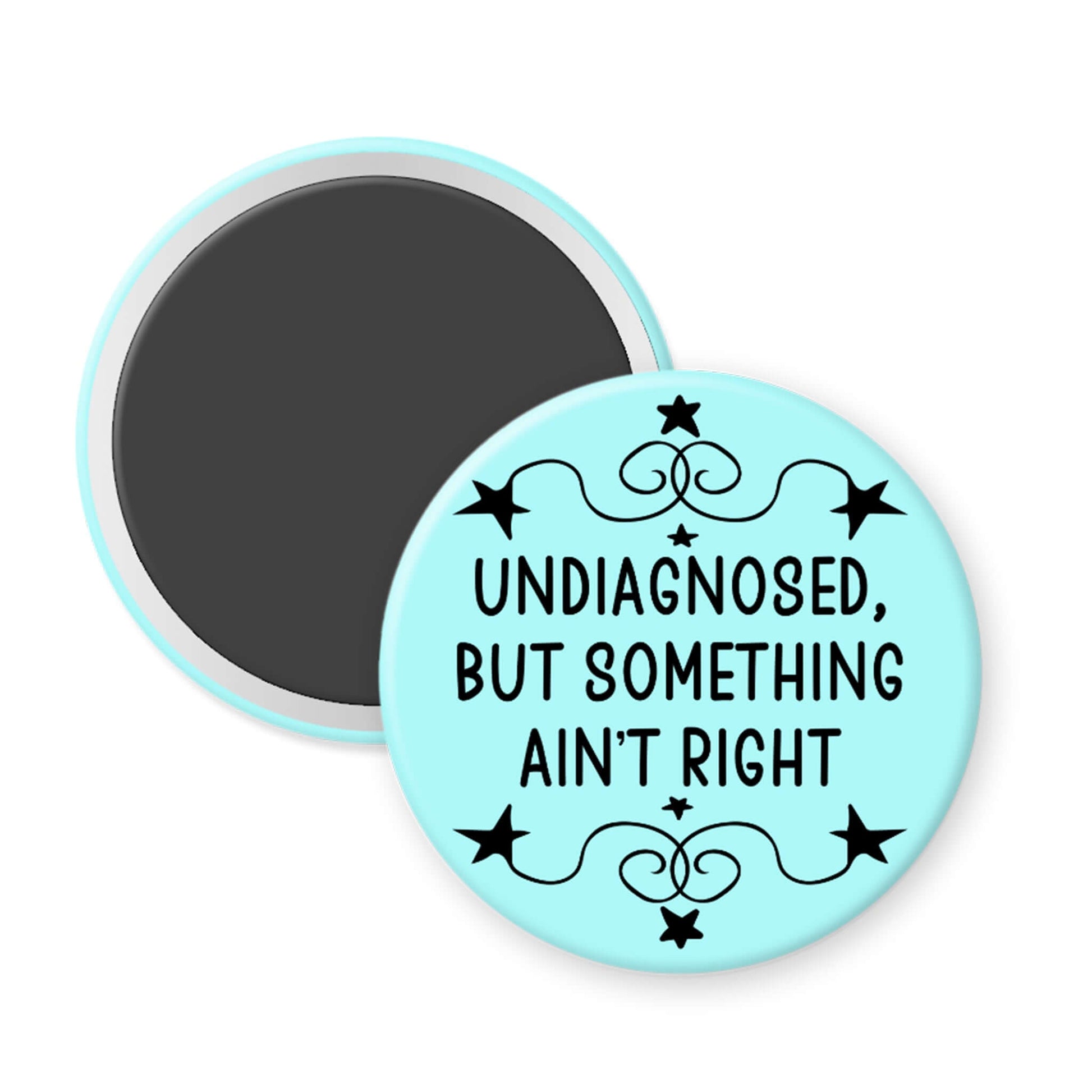 Round magnet with text 'undiagnosed, but something ain't right' on a light blue background