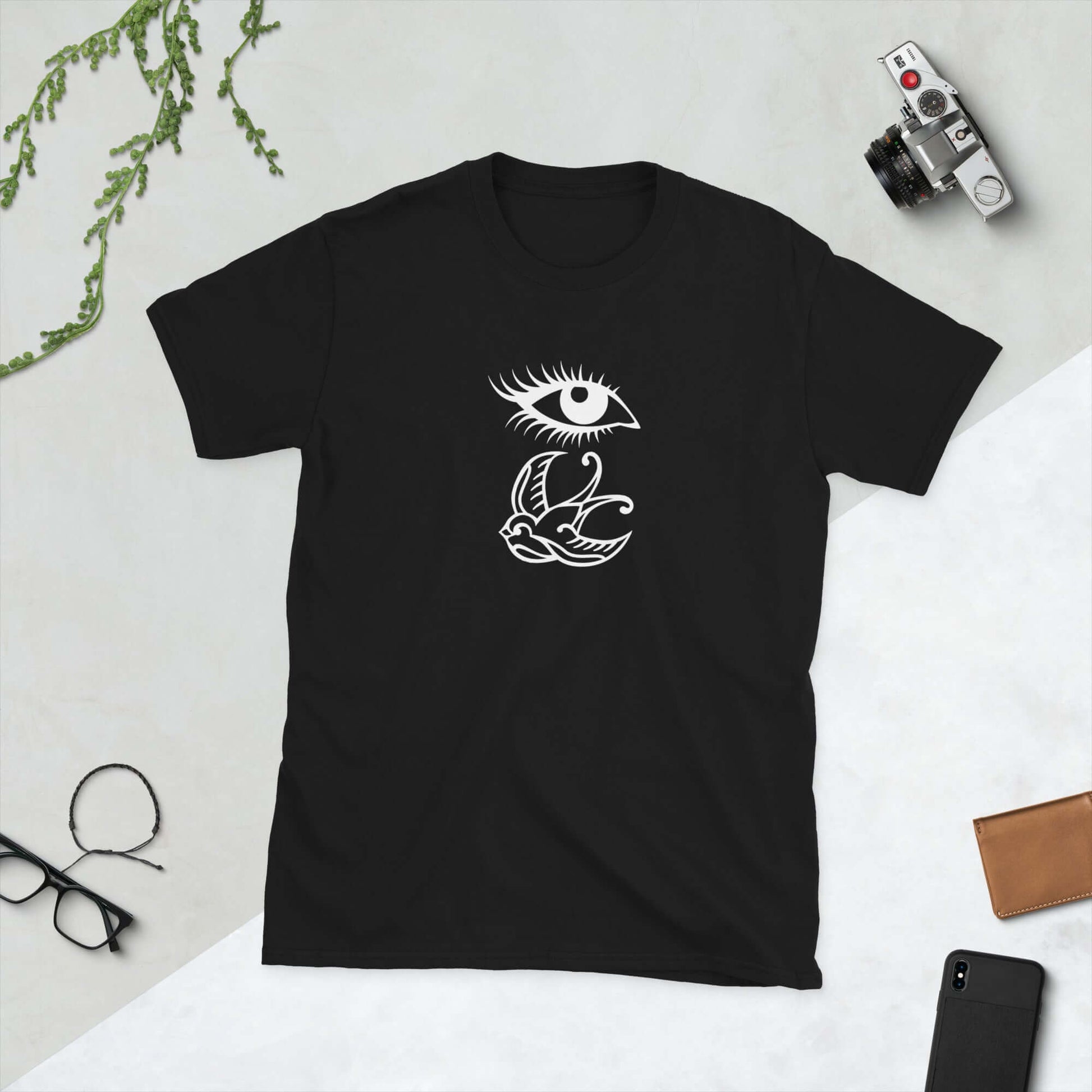 Black t-shirt with outline drawing of an eye and a swallow bird printed on the front.