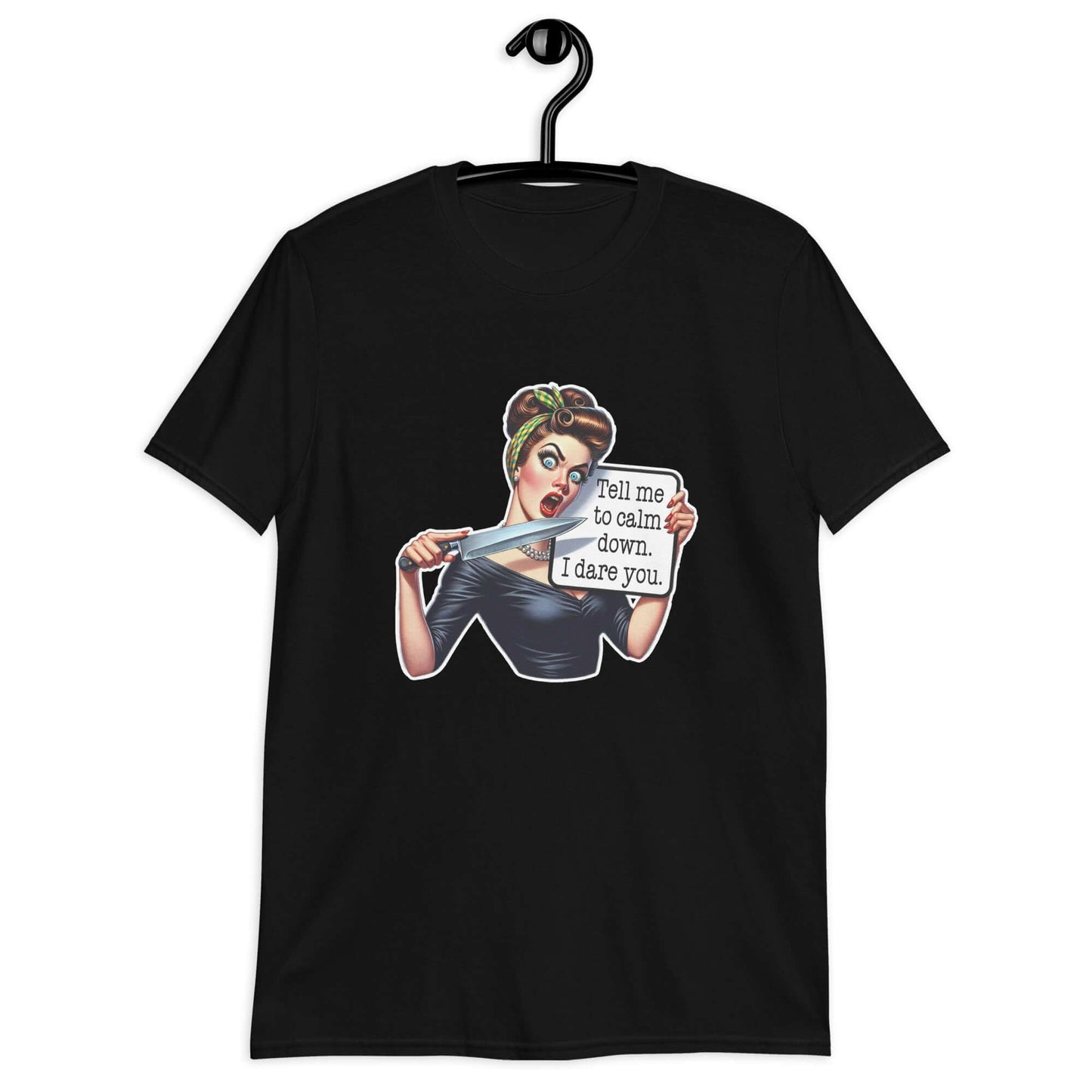 Black t-shirt displayed on a hanger. The t-shirt has a graphic of an angry looking retro woman holding a knife and a sign. The sign says Tell me to calm down I dare you. The graphic is printed on the front of the shirt.