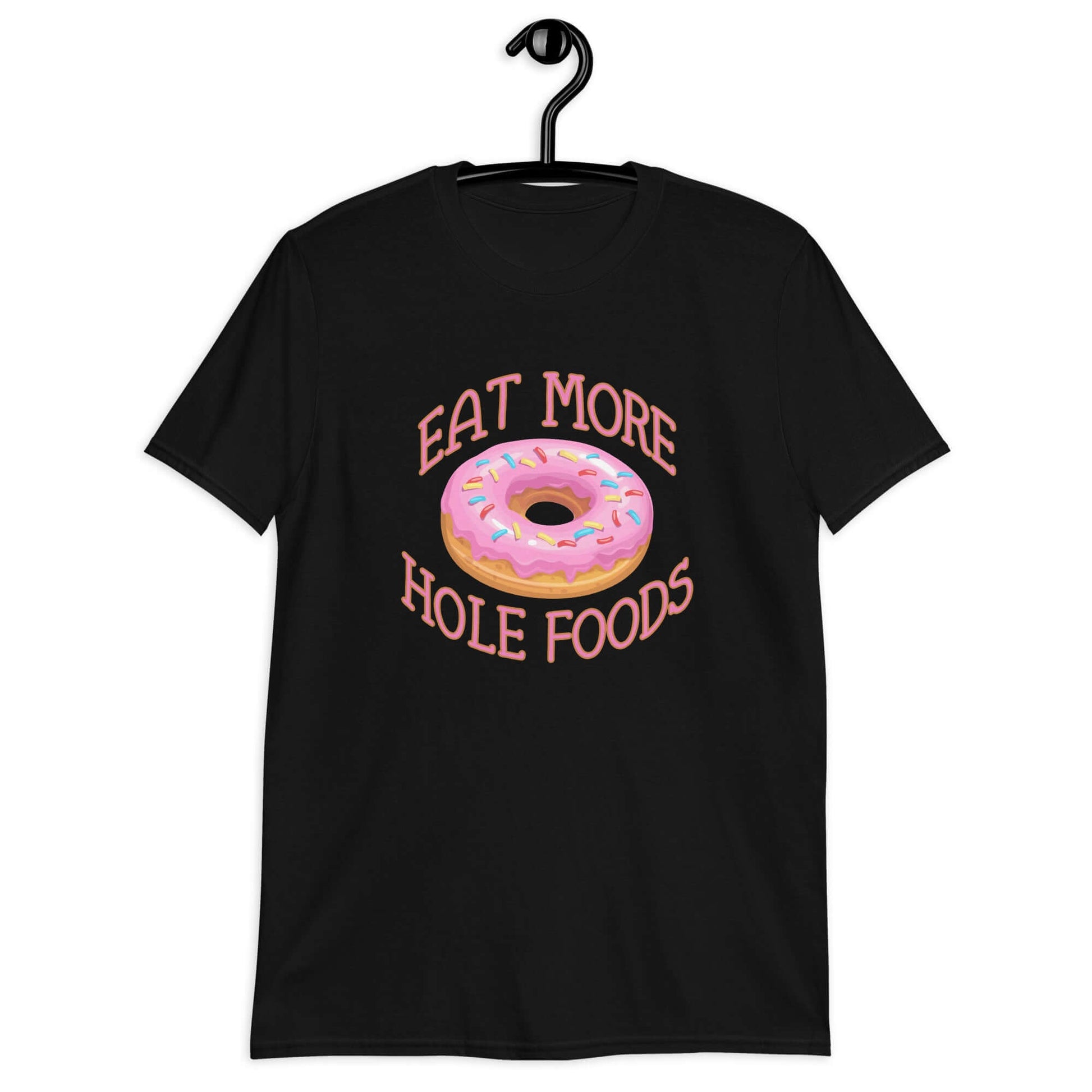 Black t-shirt that has an image of a donut with pink icing and sprinkles and Eat more hole foods printed on the front.