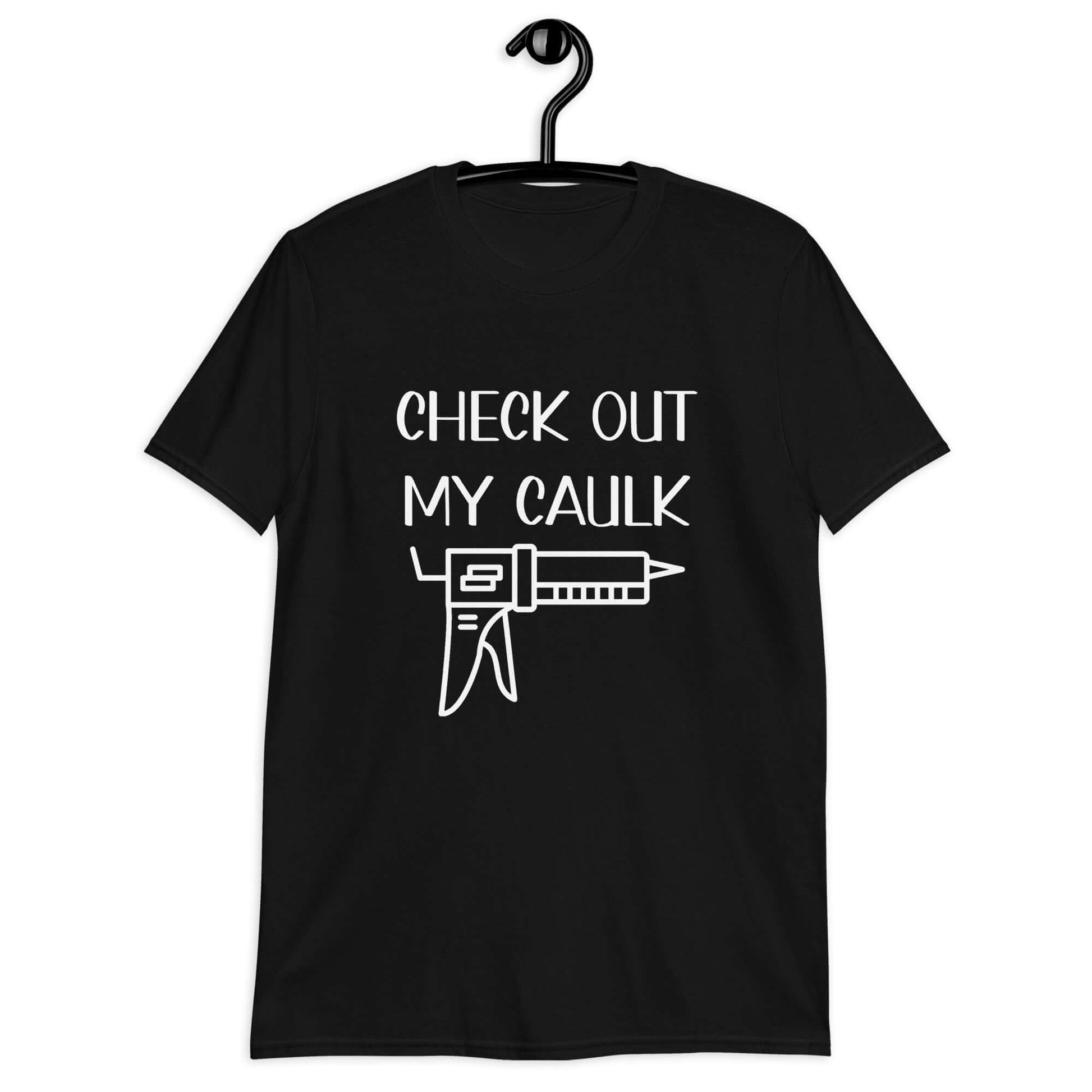 Black t-shirt with the pun phrase Check out my caulk with a line drawing image of a caulking gun printed on the front.